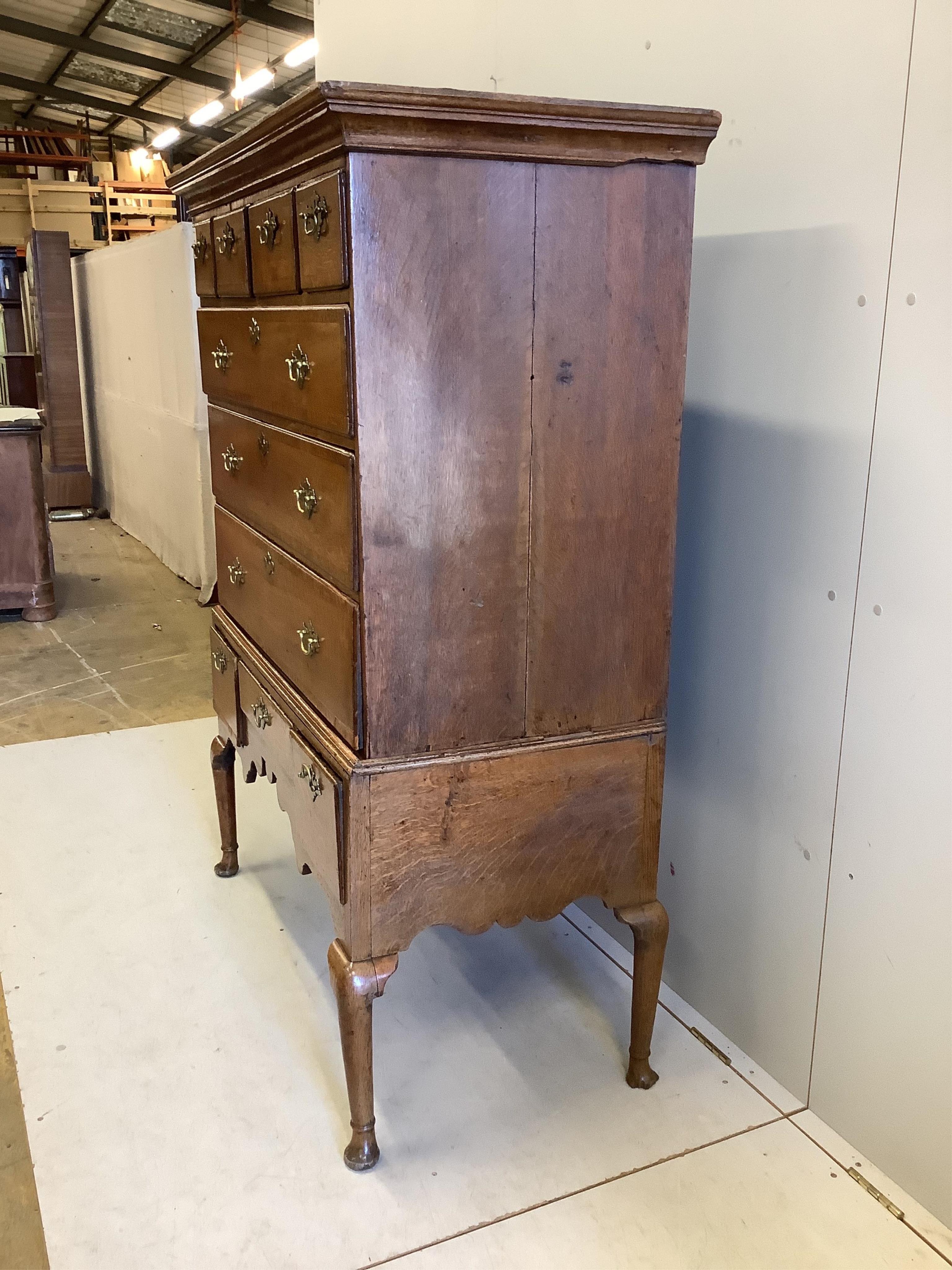 An 18th century banded oak chest on stand, width 114cm, depth 57cm, height 156cm